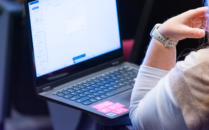 A close up photo of a person using their laptop computer.